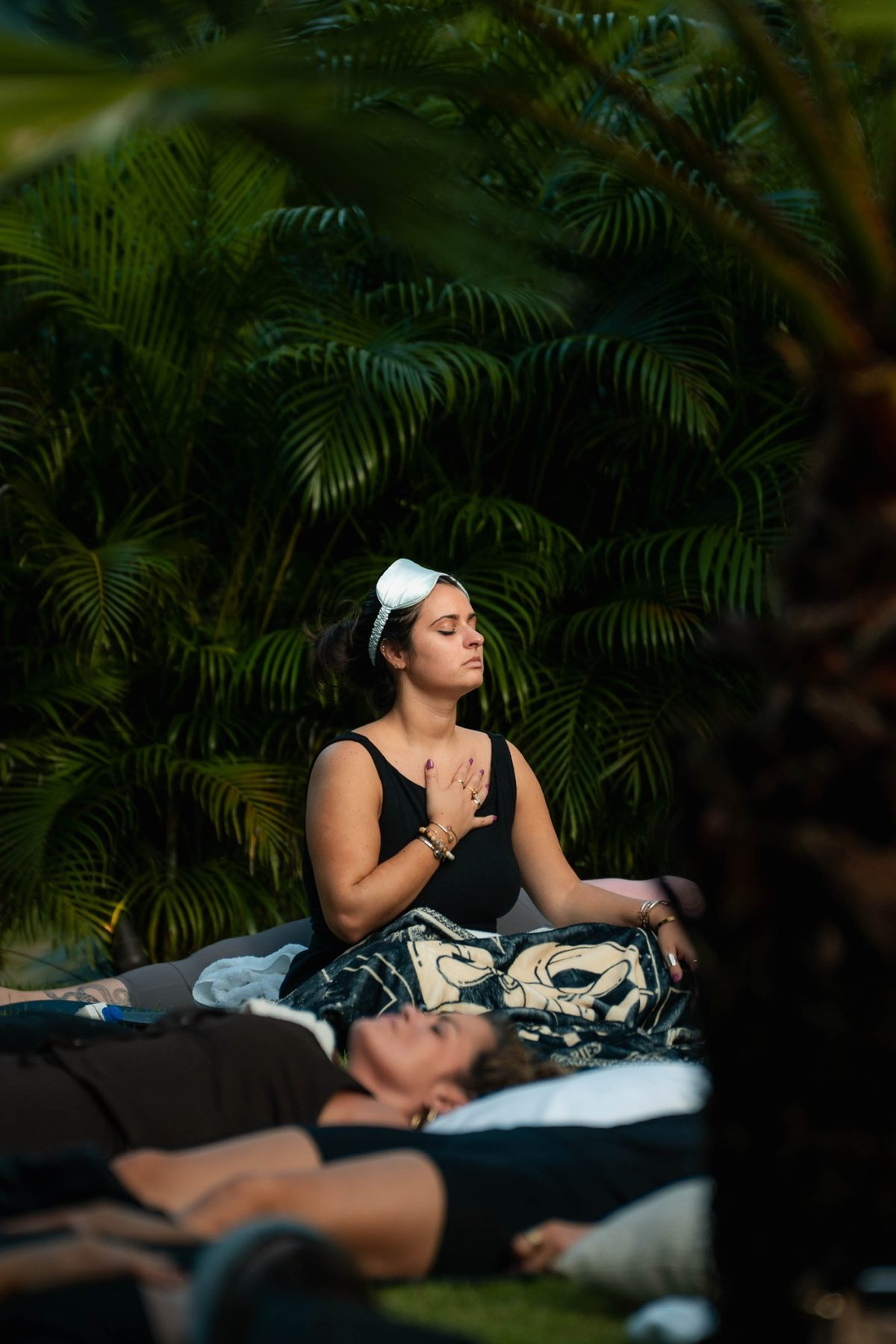 A guest with eyes closed and a hand on her heart